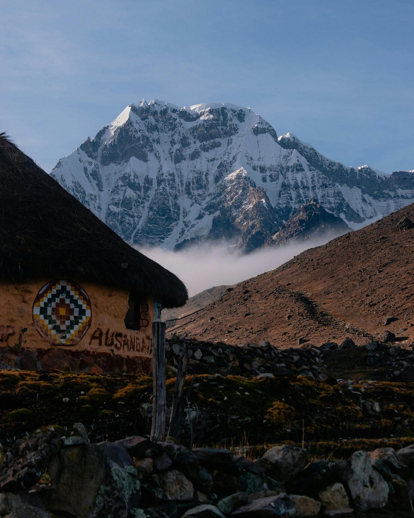 Traditional hut with a mountain in the background