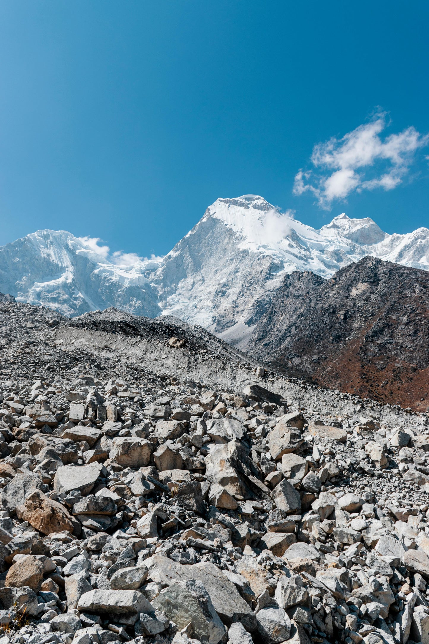 Rocky mountain landscape with snow-capped peaks under a clear blue sky.