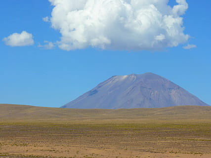 Desert landscape with a mountain under a blue sky