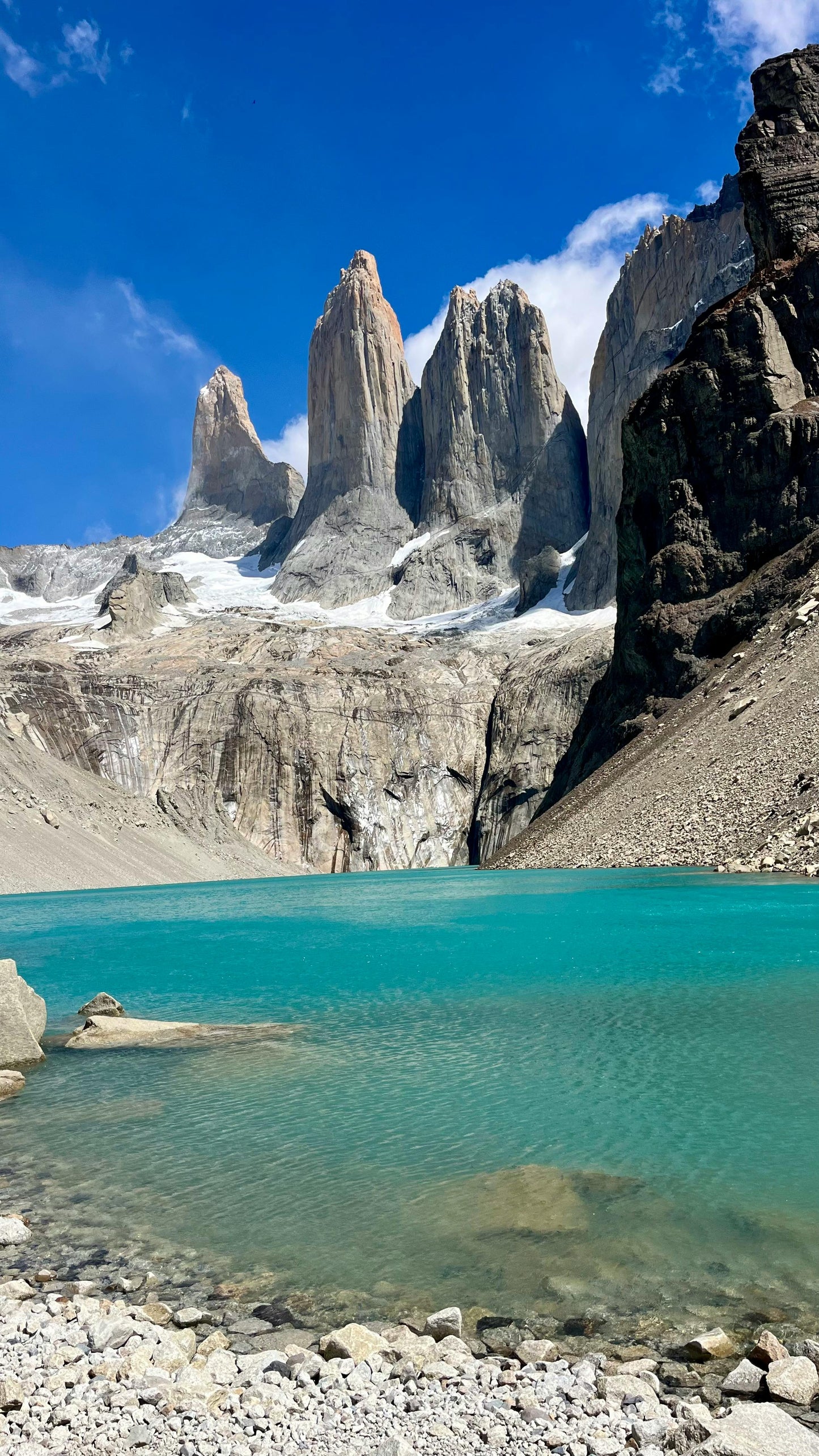 Lake with towering rock formations under a blue sky