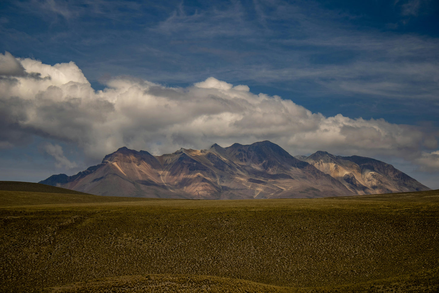Mountain range with a cloudy sky in the background