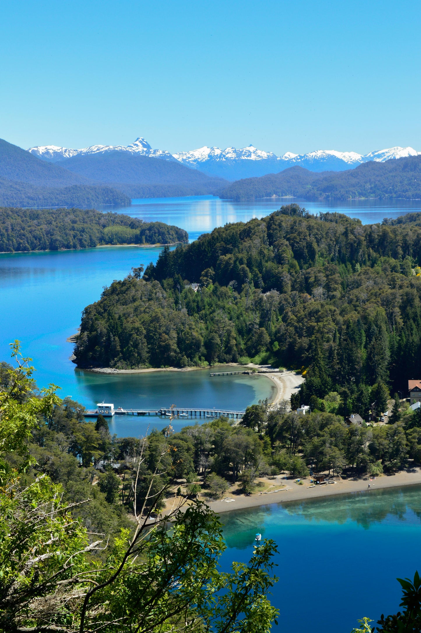 Scenic view of a lake with a dock and mountains in the background