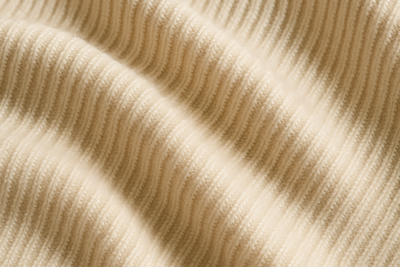I want you to create an image for the following yarn blend: Winter Luxury
Made of: 30% Baby Alpaca
30% Cashmere
30% Merino Wool
10% Silk
Develop the image in cream tones
You must show a special knit of a RIB Knits for sweaters