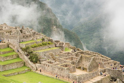 City in Choquequirao with stone ruins and greenery enveloped in mist