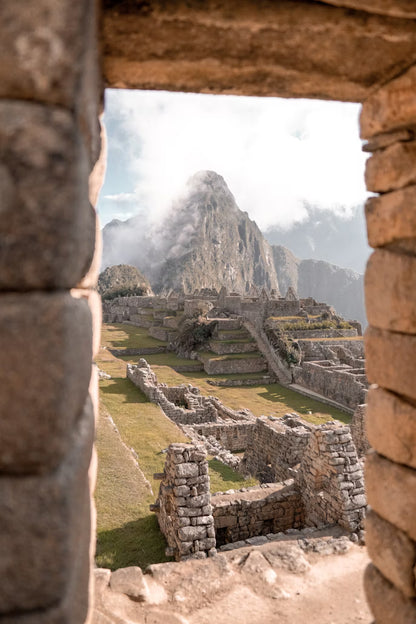 Stone ruins of Machu Picchu with a mountain in the background